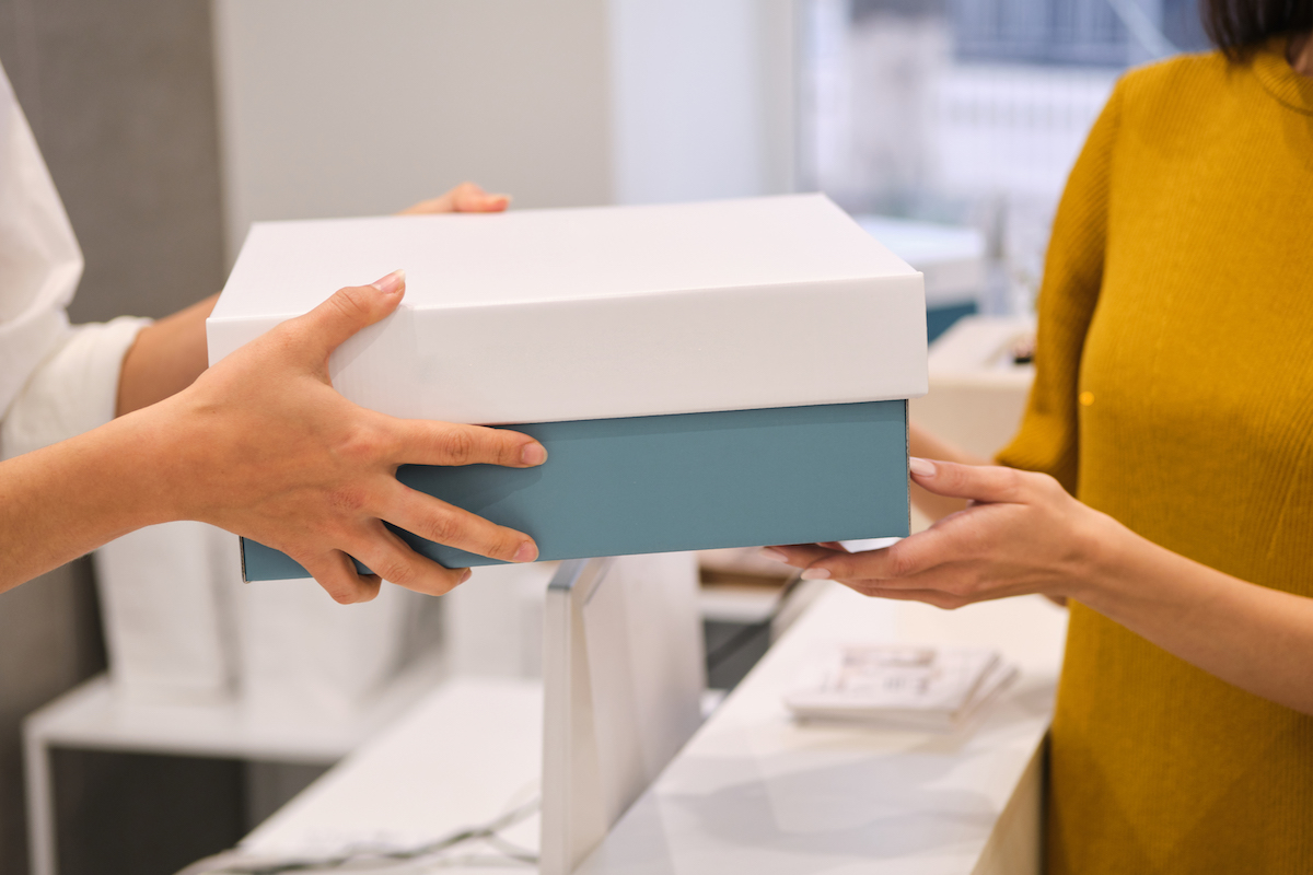 Person picking up package in store